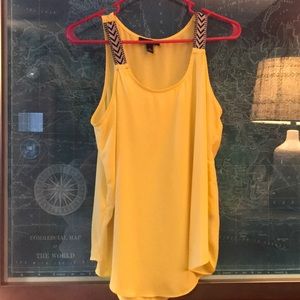 Yellow silky/flowy tank.